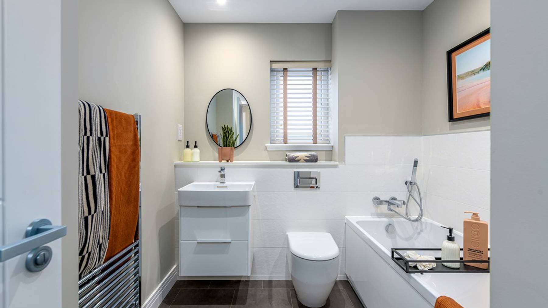 4 bedroom showhome | stylish family bathroom with sleek fittings and half-height tiling
