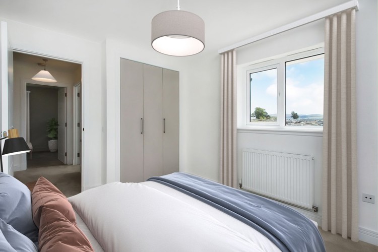 3 bedroom showhome | second bedroom with built-in storage and soft neutral tones