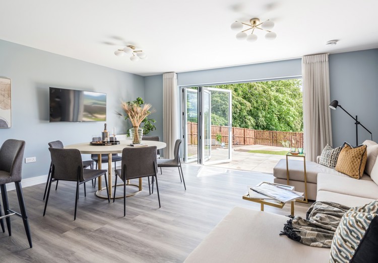 Open plan dining and family area with bifold doors into garden