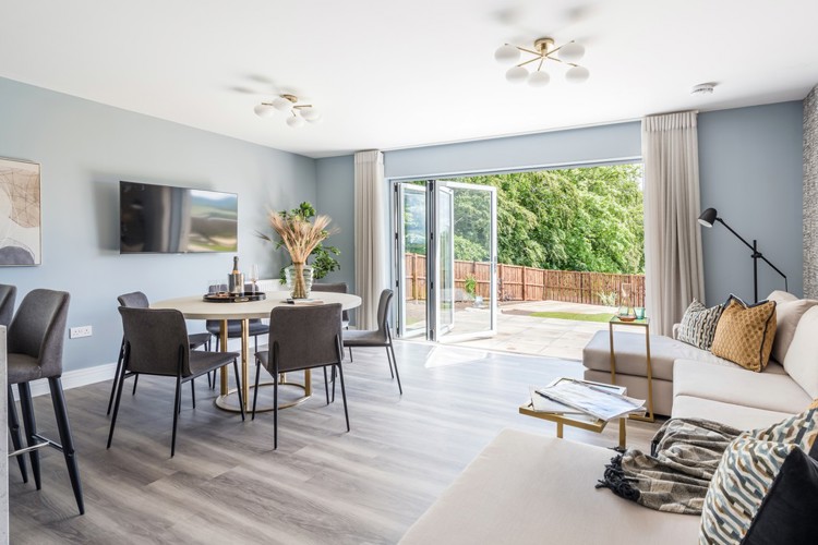 Open plan dining and family area with bifold doors into garden