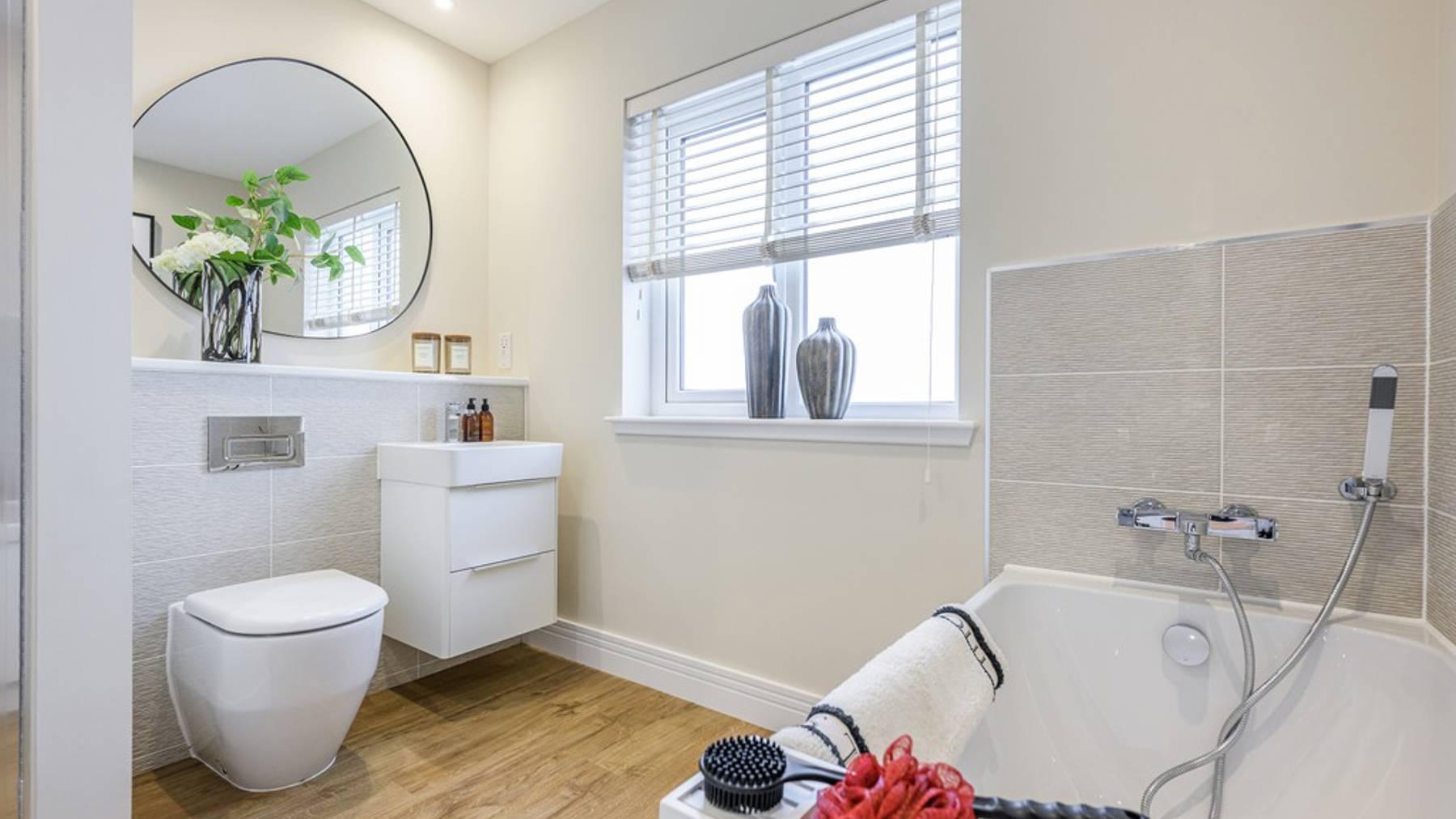 4 bedroom showhome | stylish family bathroom with sleek fittings and half-height tiling