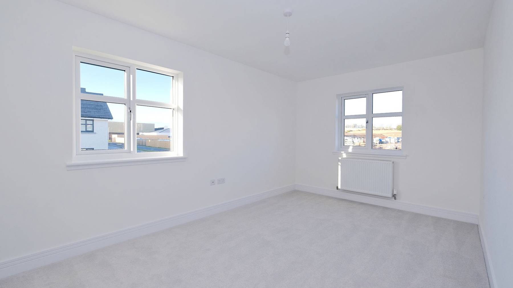 Bright bedroom with two large windows 