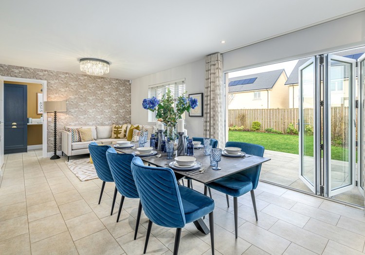 Open plan dining and family area with bifold doors into garden