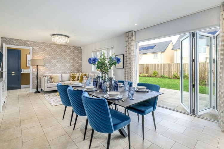 Open plan dining and family area with bifold doors into garden